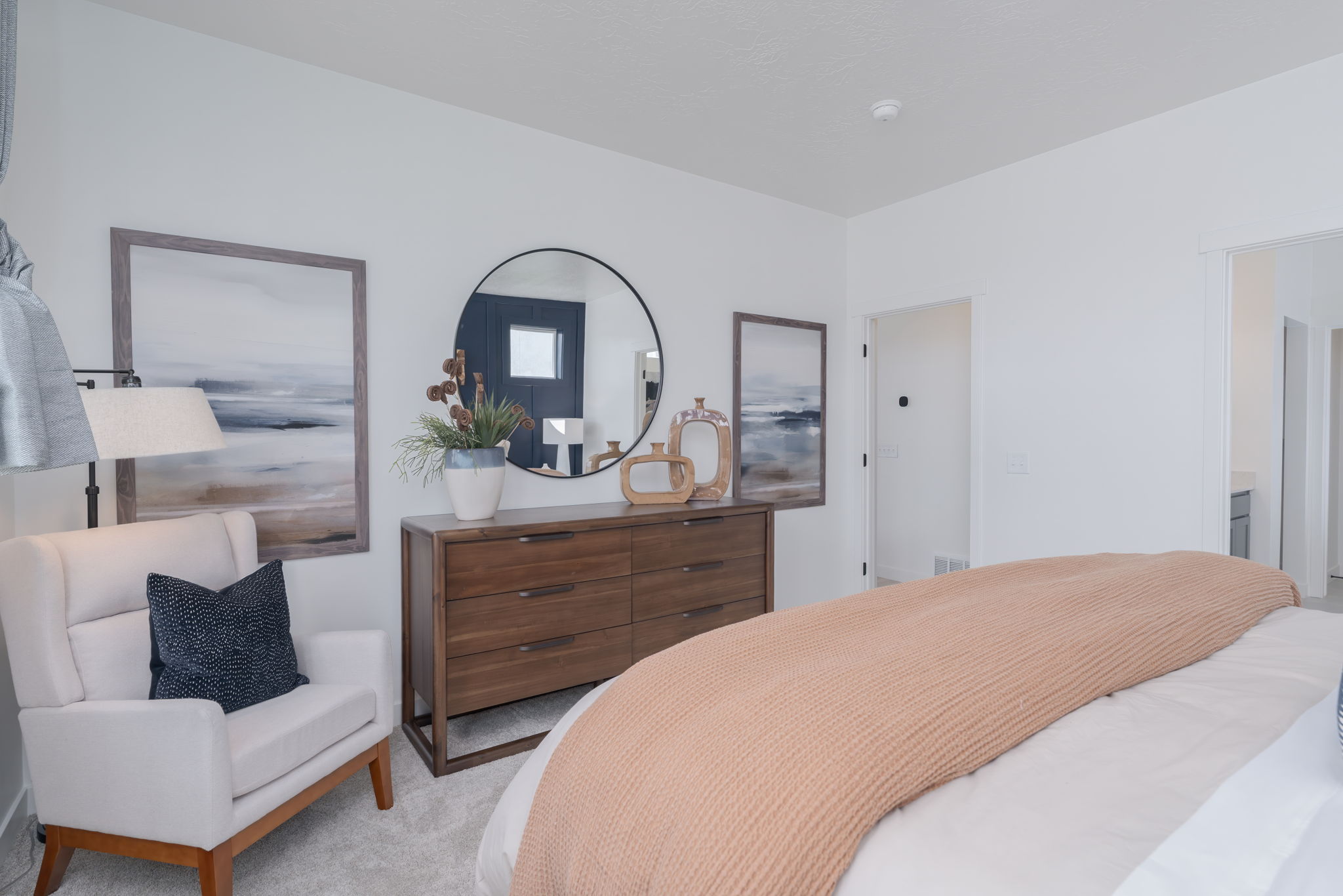 A bedroom with a bed and a chair.