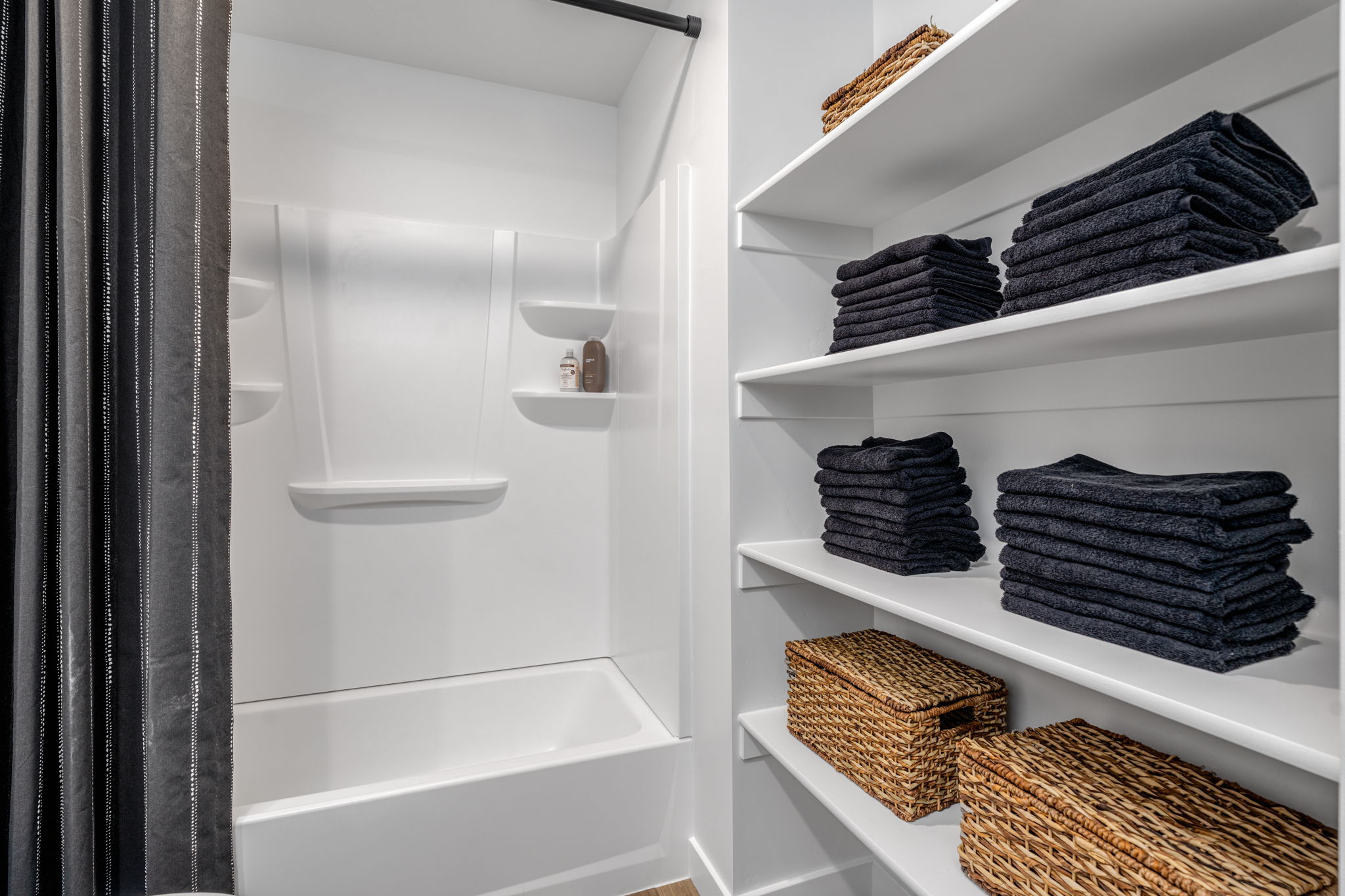 A white shelving unit with a basket and a basket with a basket.