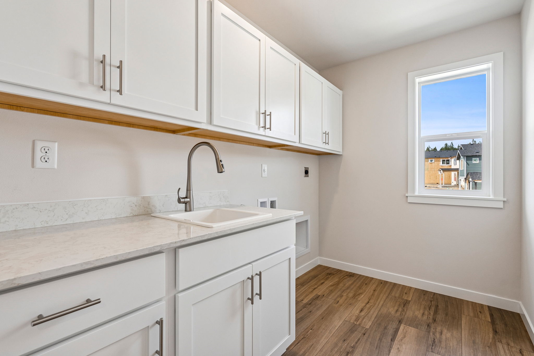 A kitchen with white cabinets.