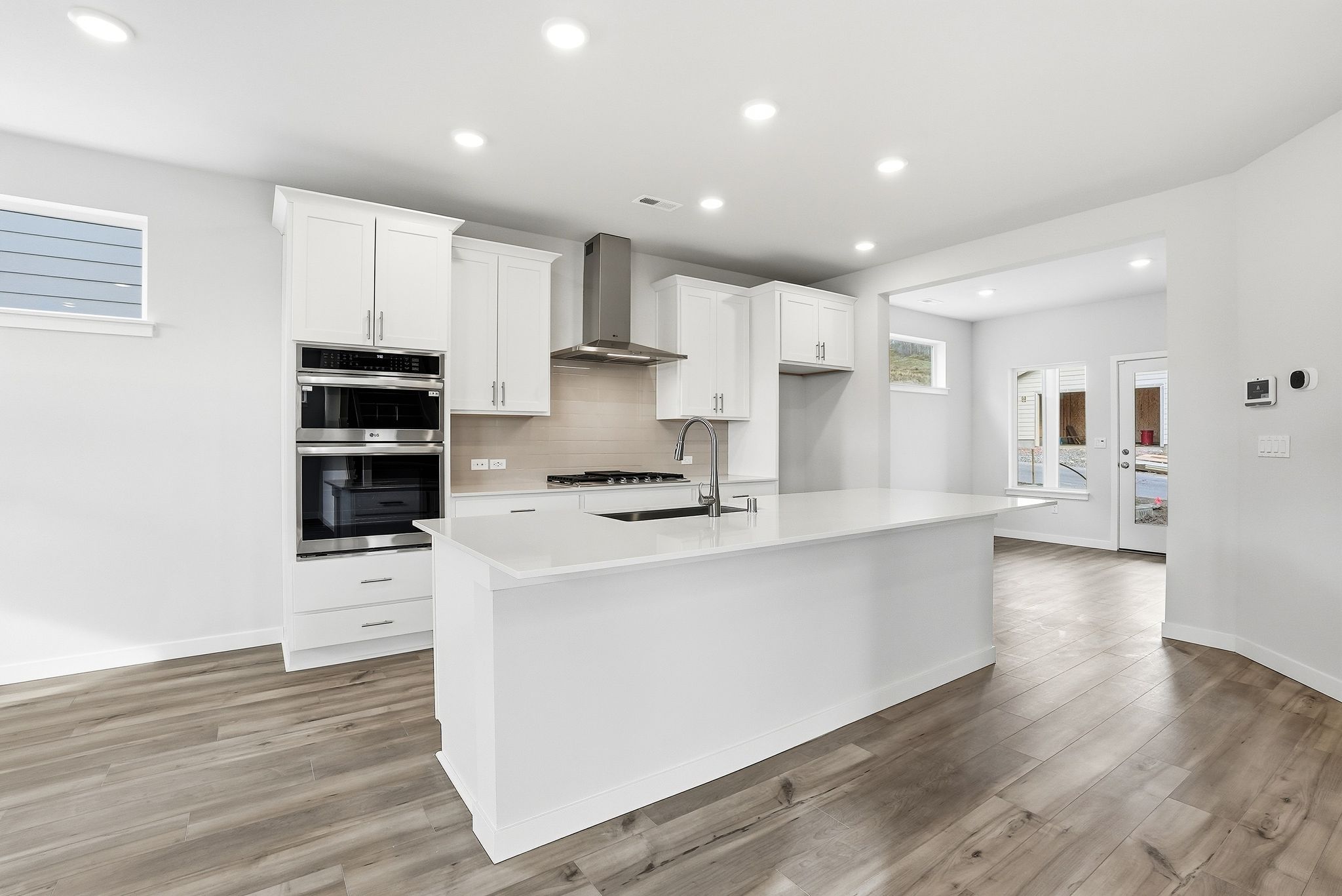 A kitchen with white cabinets.