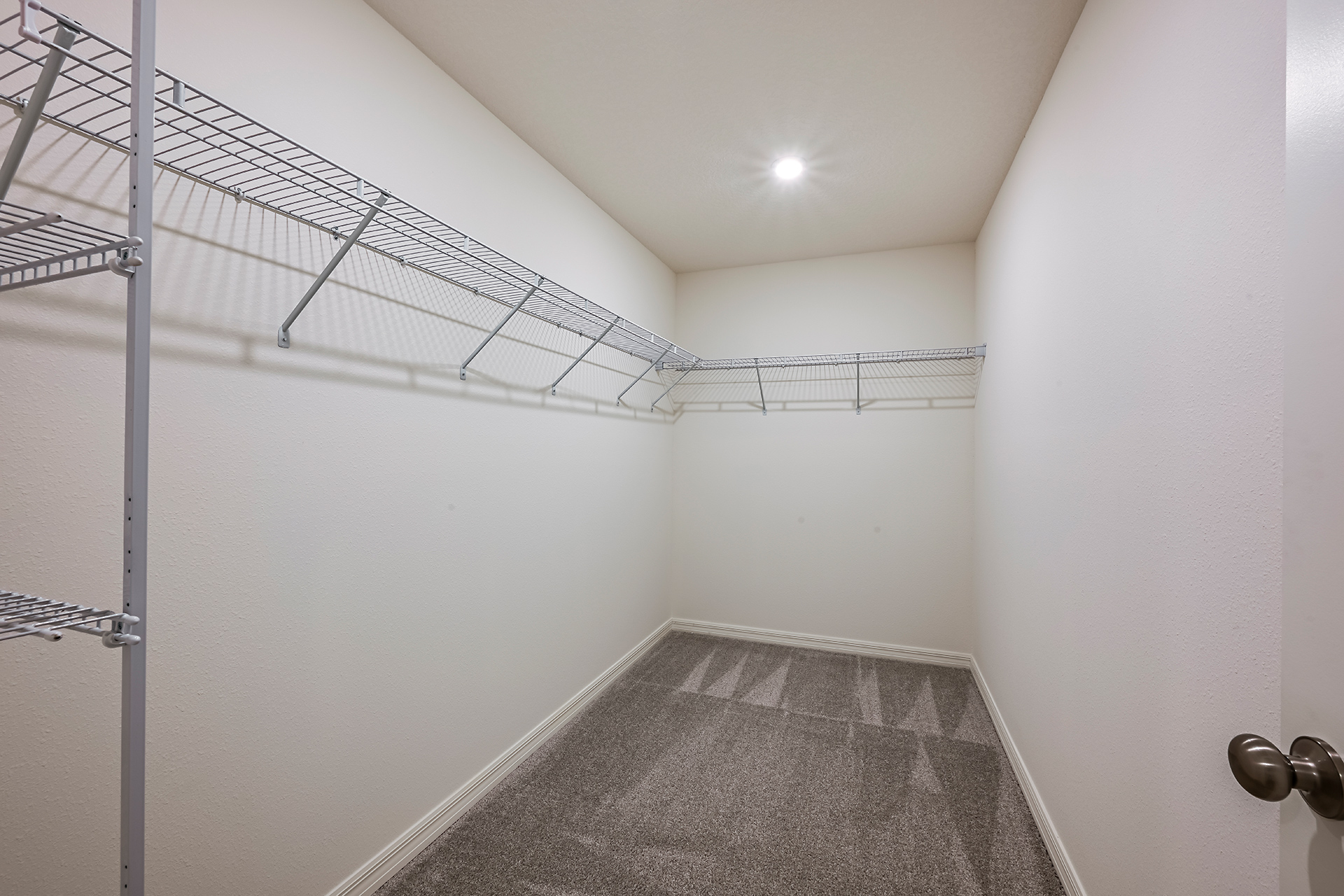 A hallway with a metal railing.