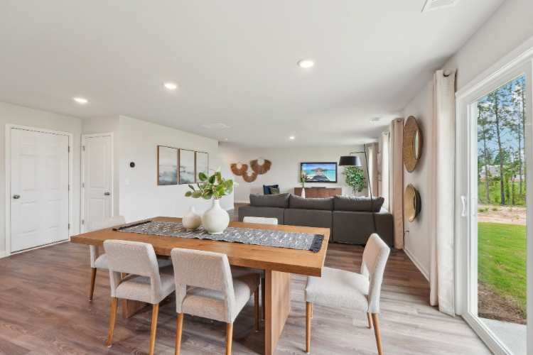 A living room with a table and chairs.