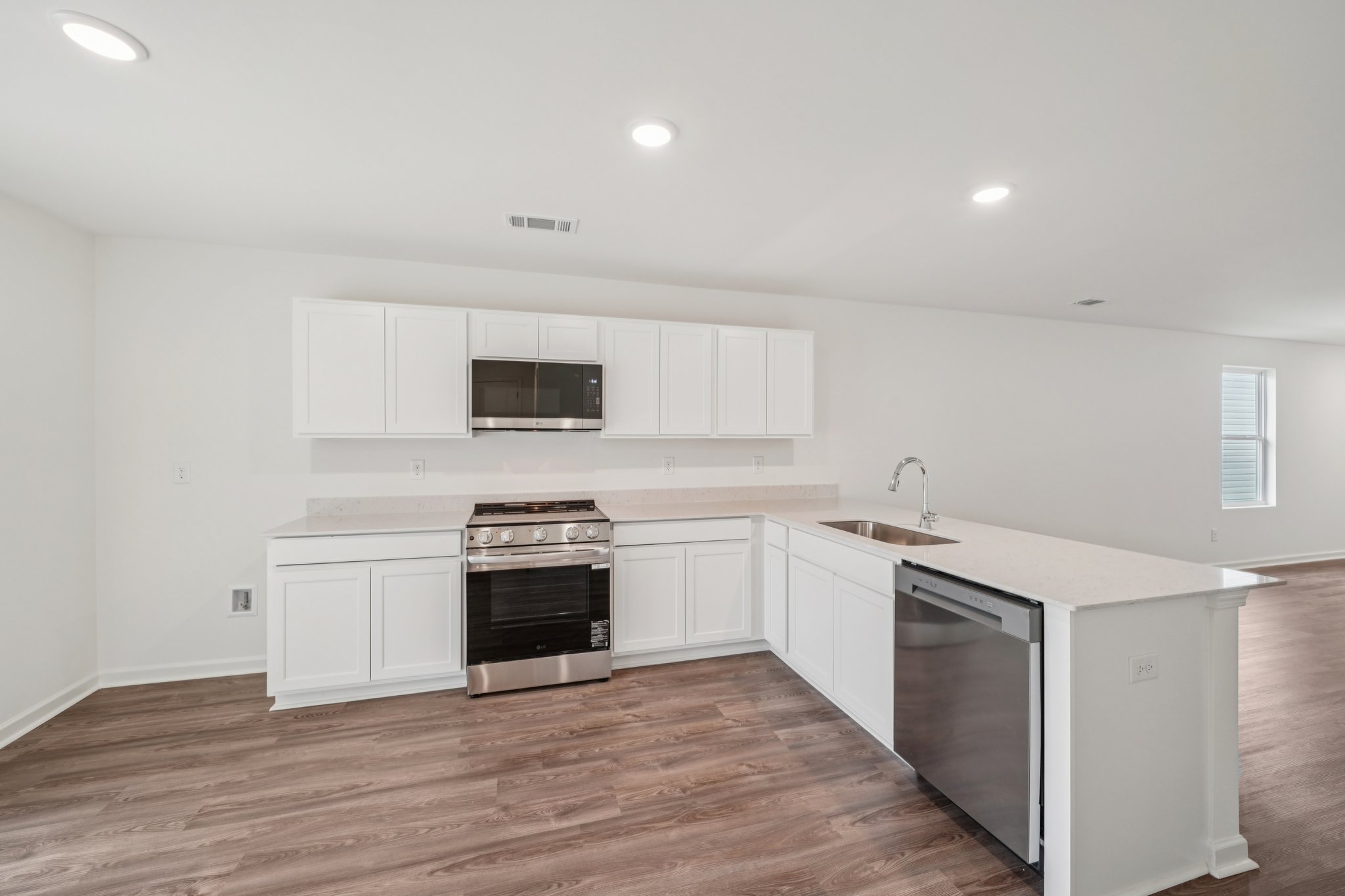 A kitchen with white cabinets.