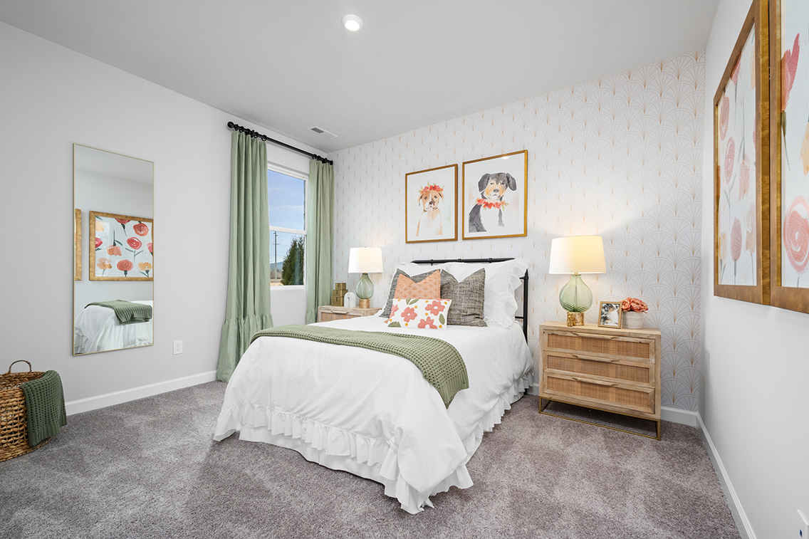 A bedroom with a bed and lamps.