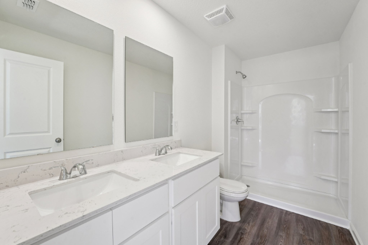 A bathroom with a tub sink and toilet.