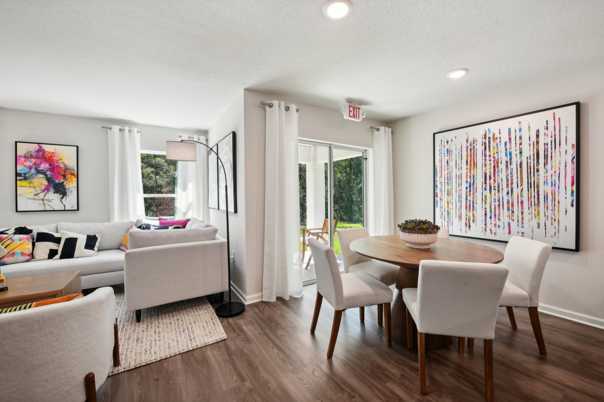 A living room with a table and chairs.