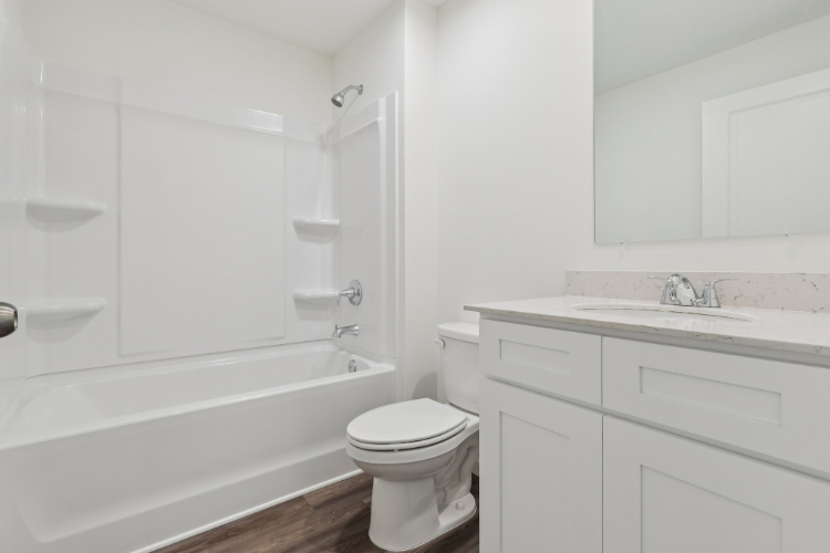 A bathroom with a tub toilet and sink.
