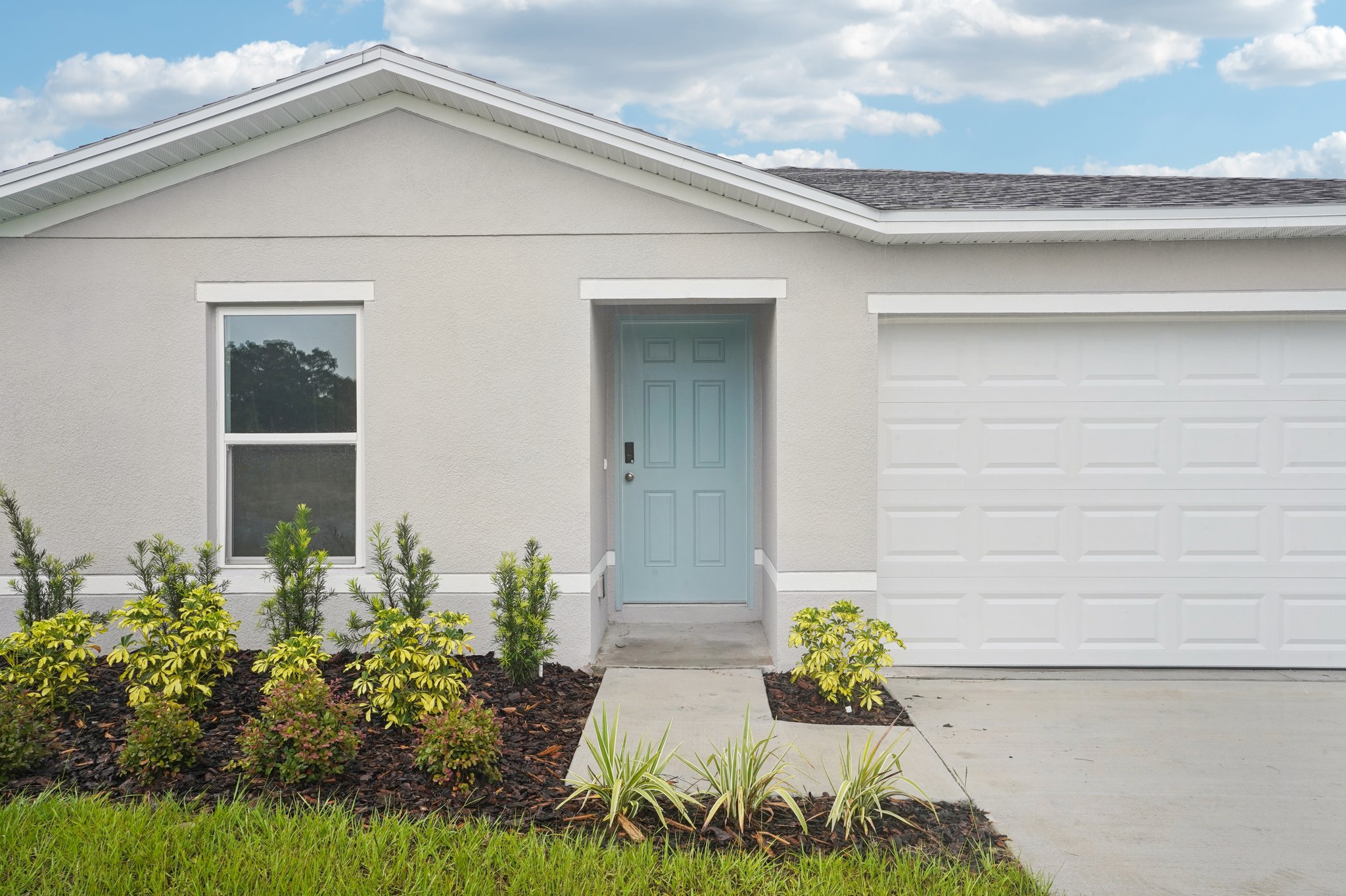 A white house with a blue door.