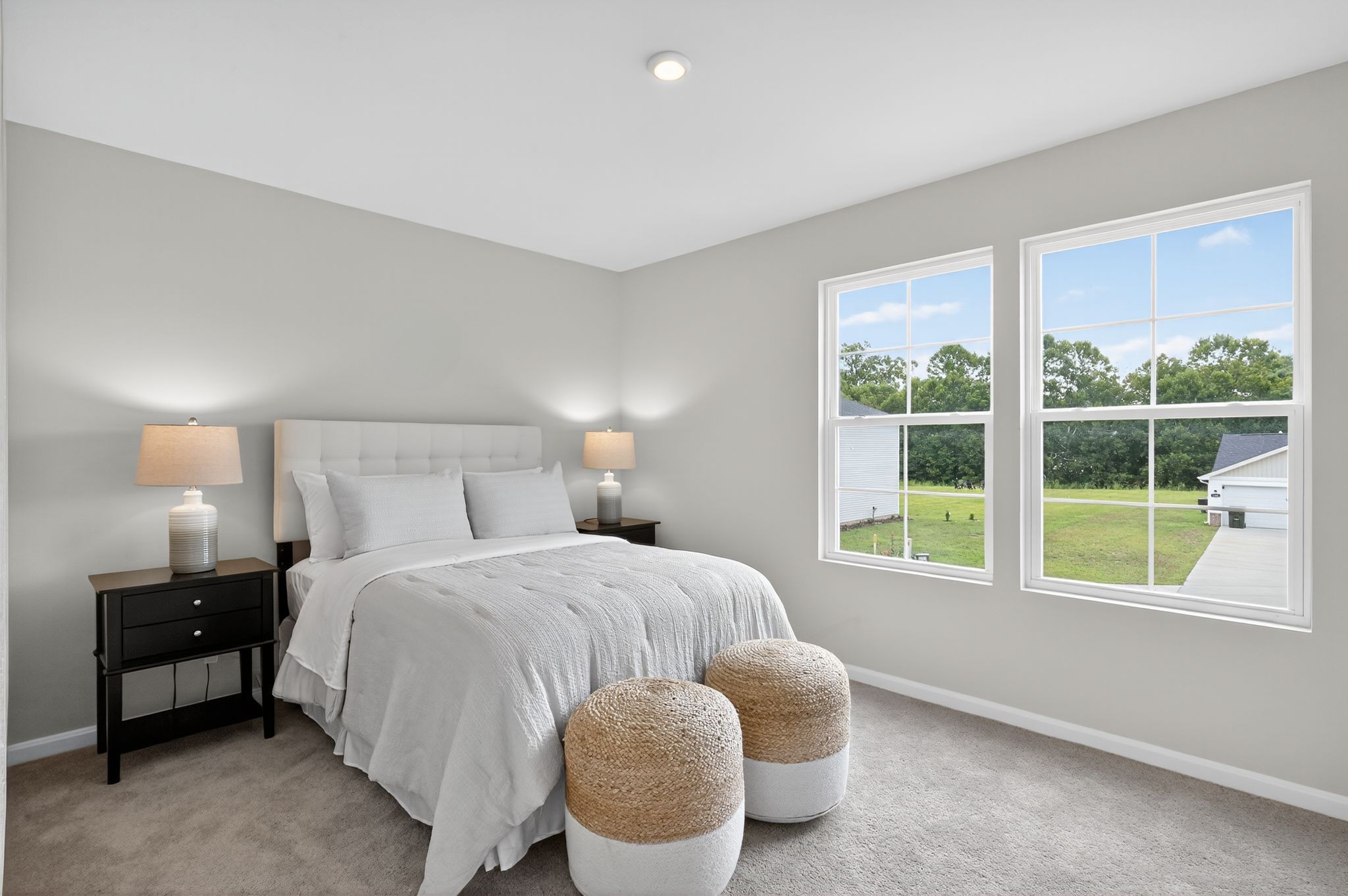 A bedroom with a bed and a window.