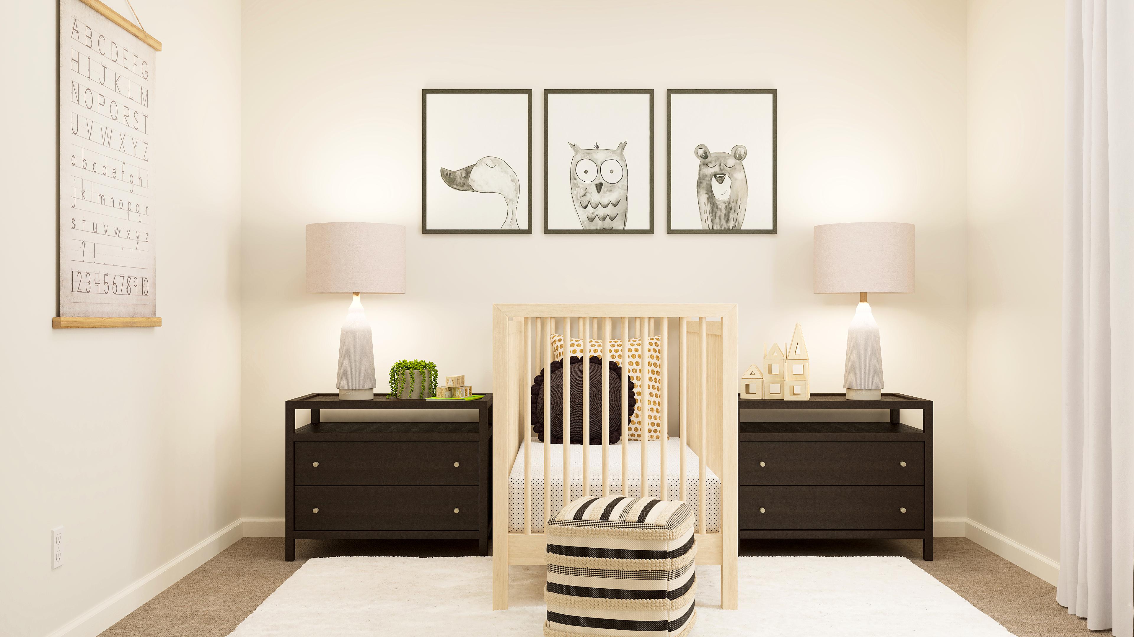 A room with a crib and a dresser with pictures on the wall.