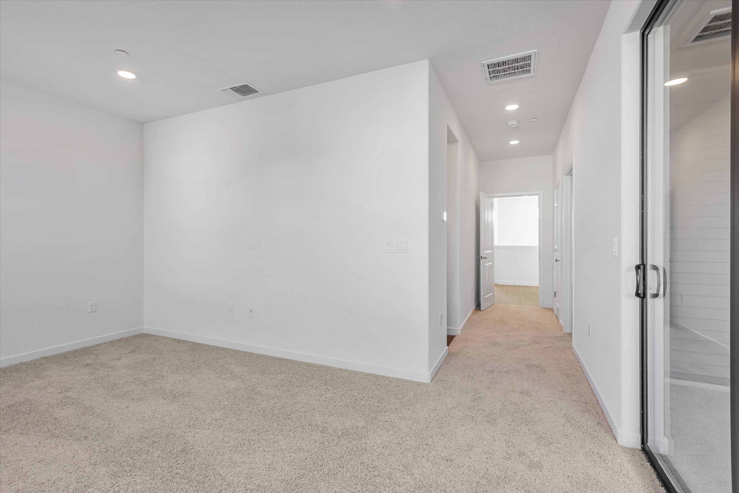 A hallway with white walls.